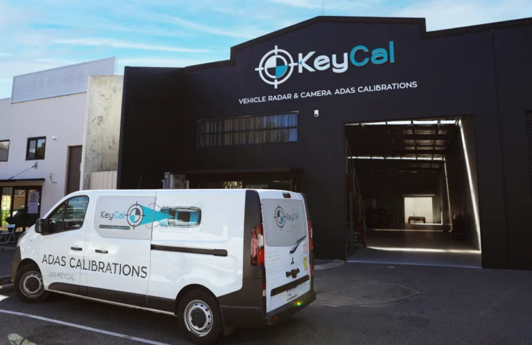 KeyCAL van parked outside black-painted headquarters in Perth with branding visible
