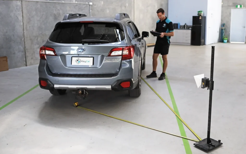 KeyCAL technician conducting ADAS rear calibration on Subaru in workshop