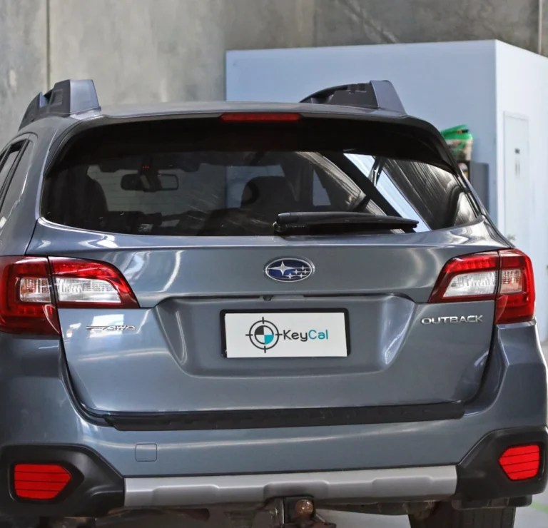 Subaru Outback positioned in KeyCAL workshop displaying branded license plate