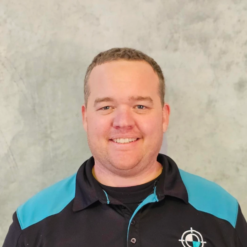 KeyCAL staff member in branded hoodie standing in front of concrete wall