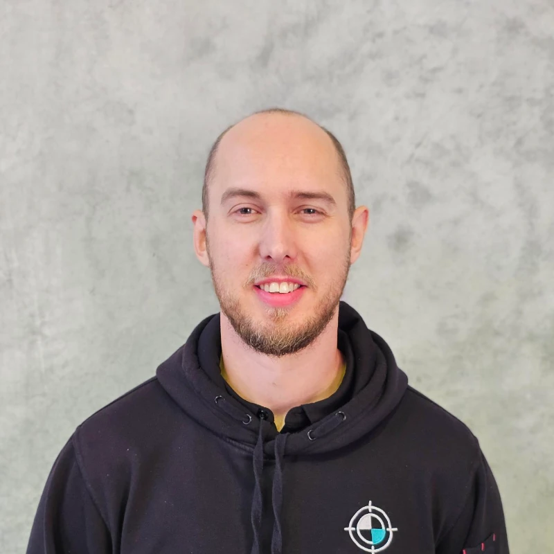 KeyCAL staff member in branded hoodie standing in front of concrete wall