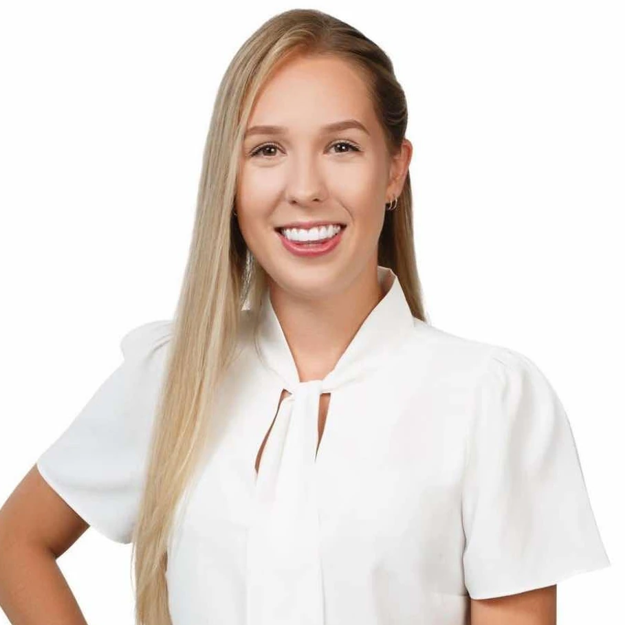 Smiling female staff member at KeyCAL wearing white blouse